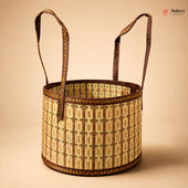 A round woven basket with two long handles, made from natural straw and dark brown trim, shown on a solid beige background. A Bakeey logo is visible in the top right corner.