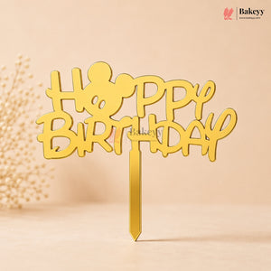 Gold 'Happy Birthday' cake topper on a beige background