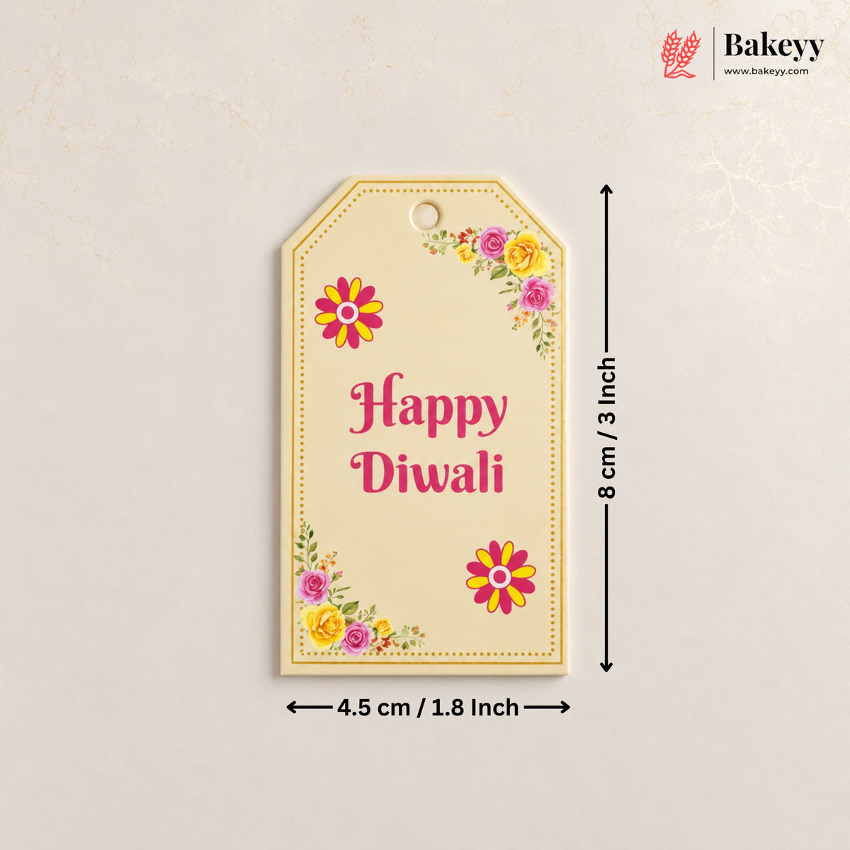 A decorative Diwali gift tag with floral corner designs and the words 'Happy Diwali' in pink, shown with dimension arrows indicating 8 cm by 4.5 cm.