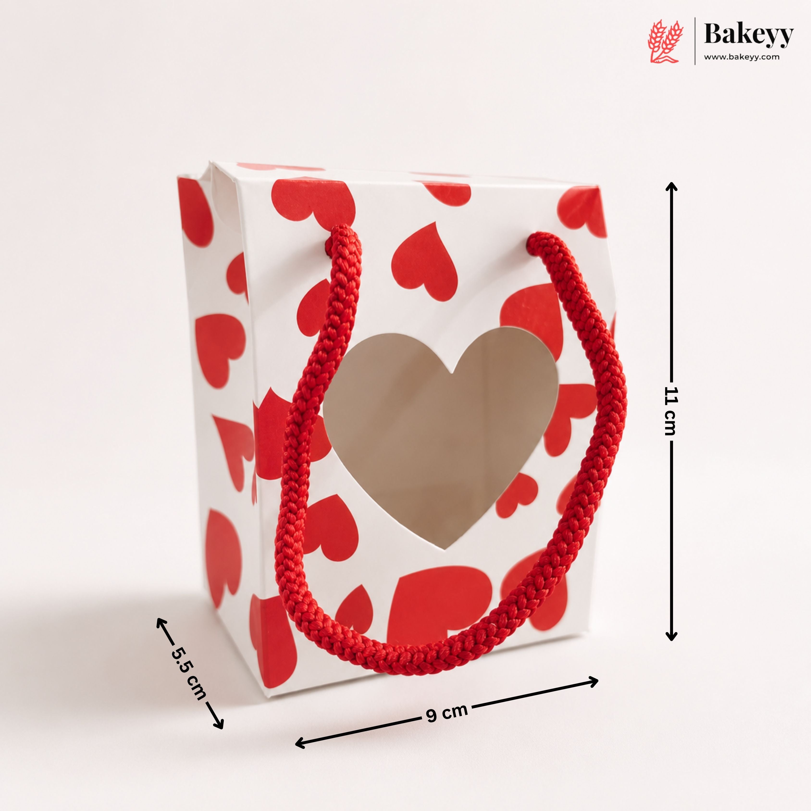 Gift bag with red heart pattern and dimensions labeled, featuring the Bakeyy brand.