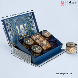A blue decorative gift box for tea or snacks, shown open with dimension arrows and labels indicating measurements. The box has an illustrated blue-and-white architectural pattern on the lid and exterior, a dark blue satin interior, and several round tin containers with lids inside.
