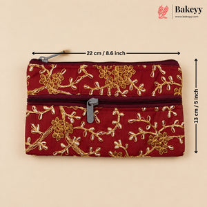 A red quilted zippered pouch with gold floral embroidery, shown on a beige background with dimension lines indicating 22 cm by 13 cm. The Bakeyy logo is visible in the top right corner.