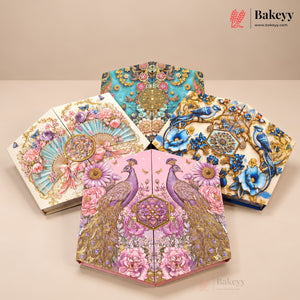 Four decorative fan-shaped baked goods or pastries displayed on a beige studio surface, each with intricate floral and bird illustrations. The designs include turquoise, pink, blue, and cream backgrounds with gold detailing, peacocks, flowers, and birds.