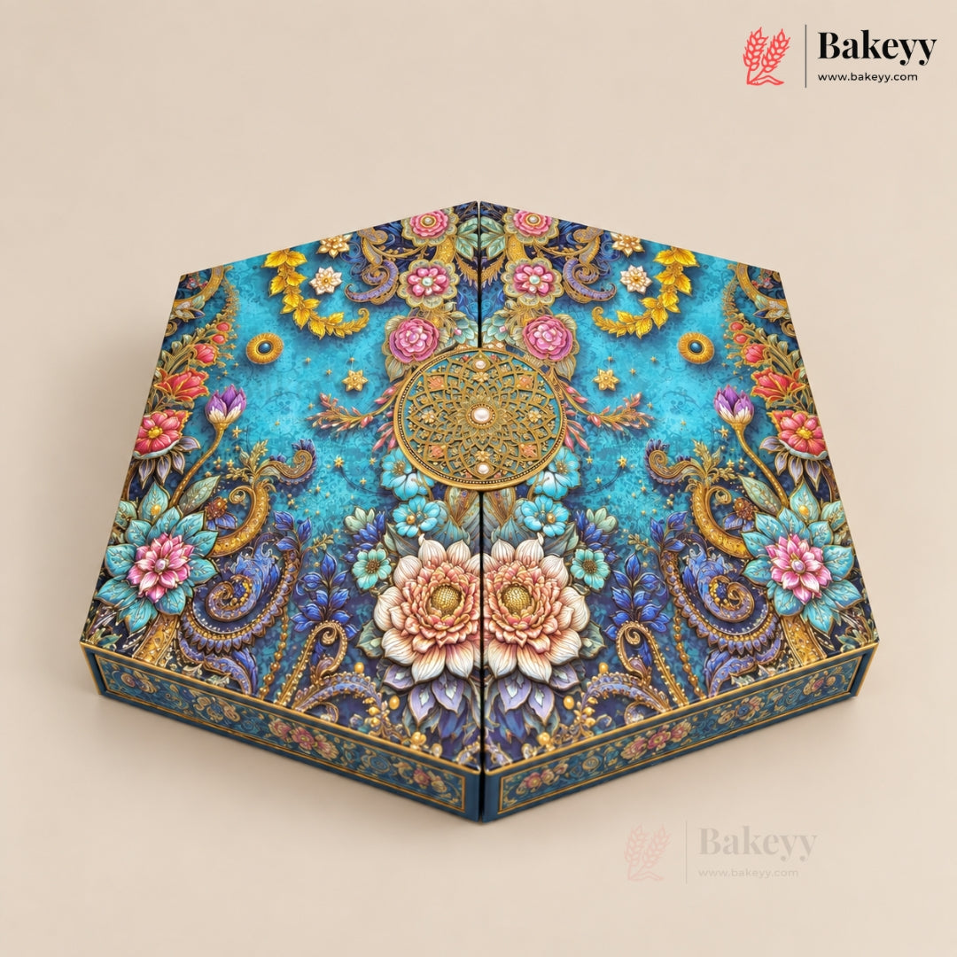 Hexagonal decorative cake box with an intricate floral and paisley pattern in turquoise, gold, pink, and blue, shown on a beige background with the Bakeyy brand logo in the top right.