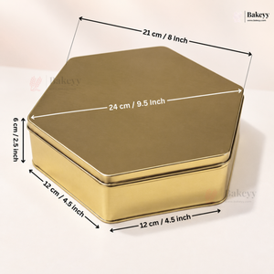 A hexagonal gold metal tin with overlaid dimension arrows and labels showing 21 cm by 24 cm by 12 cm measurements on a light beige background.