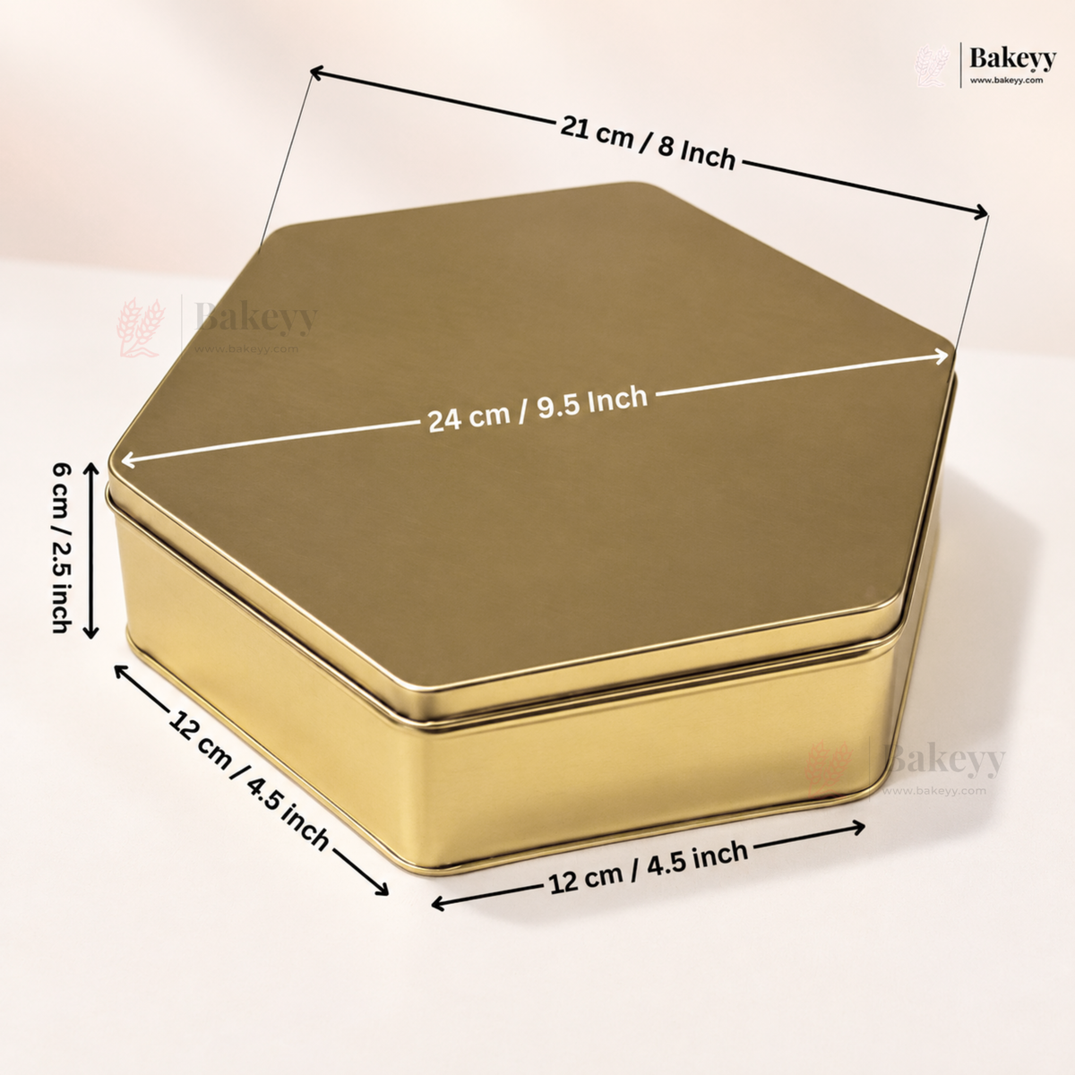 A hexagonal gold metal tin with overlaid dimension arrows and labels showing 21 cm by 24 cm by 12 cm measurements on a light beige background.