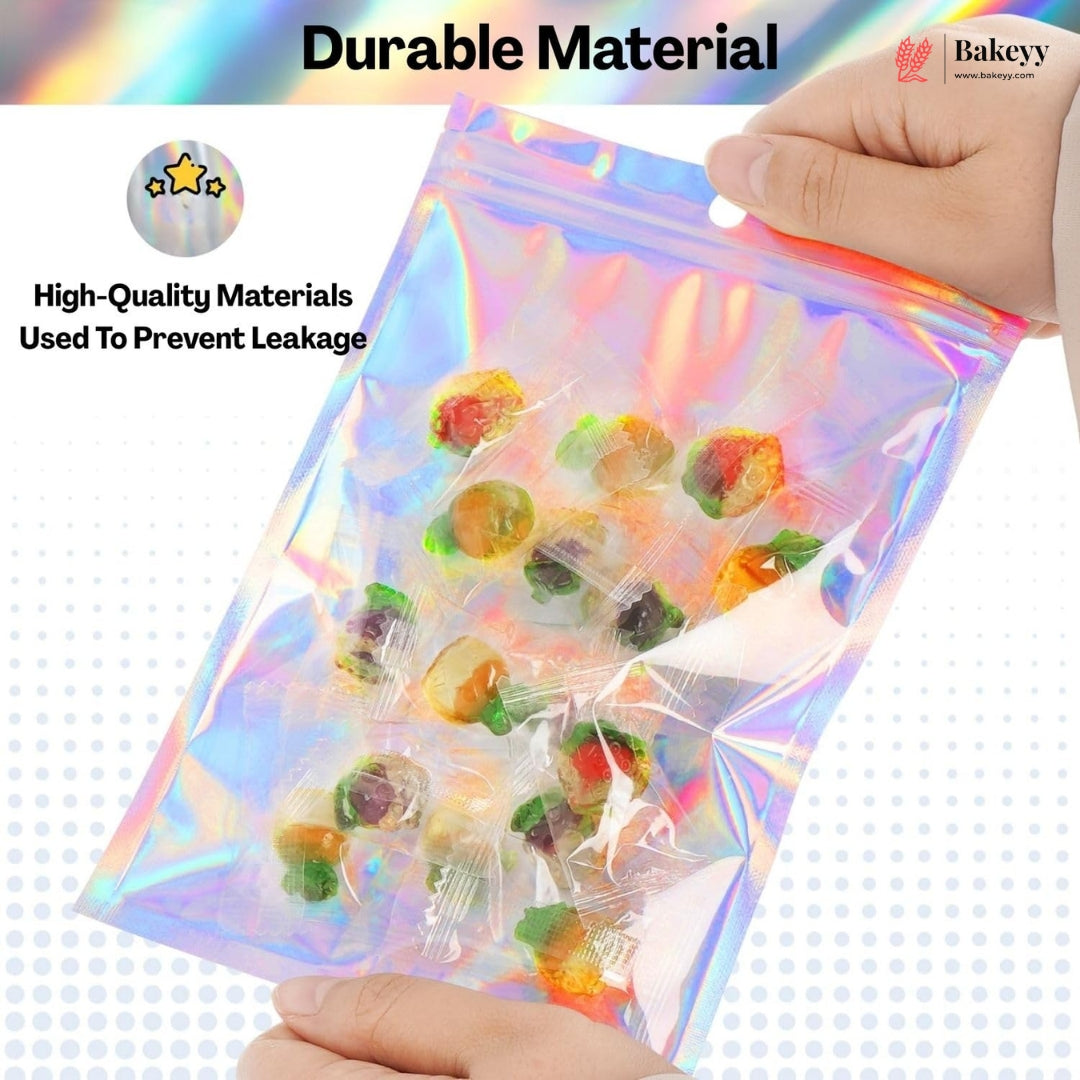 A hand holds a transparent holographic zip-top bag filled with assorted colorful gummy candies. The image includes marketing text reading 'Durable Material' and 'High-Quality Materials Used To Prevent Leakage,' with a Bakeey logo in the top right.