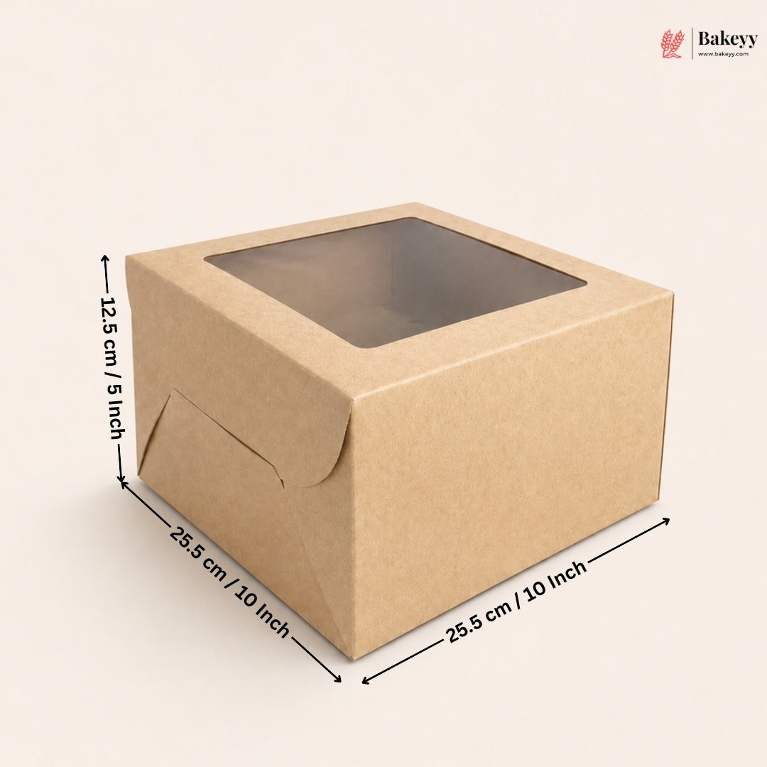 A square brown kraft paper bakery box with a clear window on top, shown with dimension arrows and labels indicating 25.5 cm by 25.