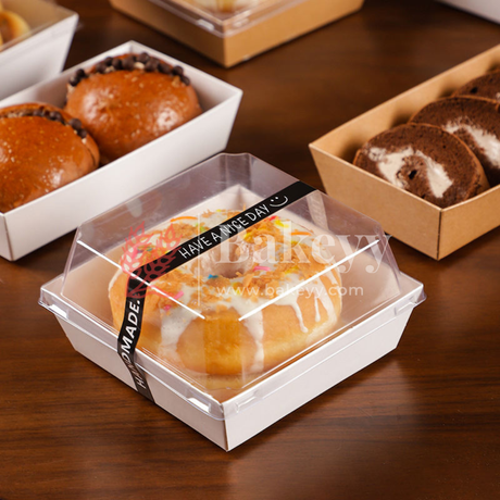 Baked goods in transparent containers on a wooden surface with 'bakeyy' branding.