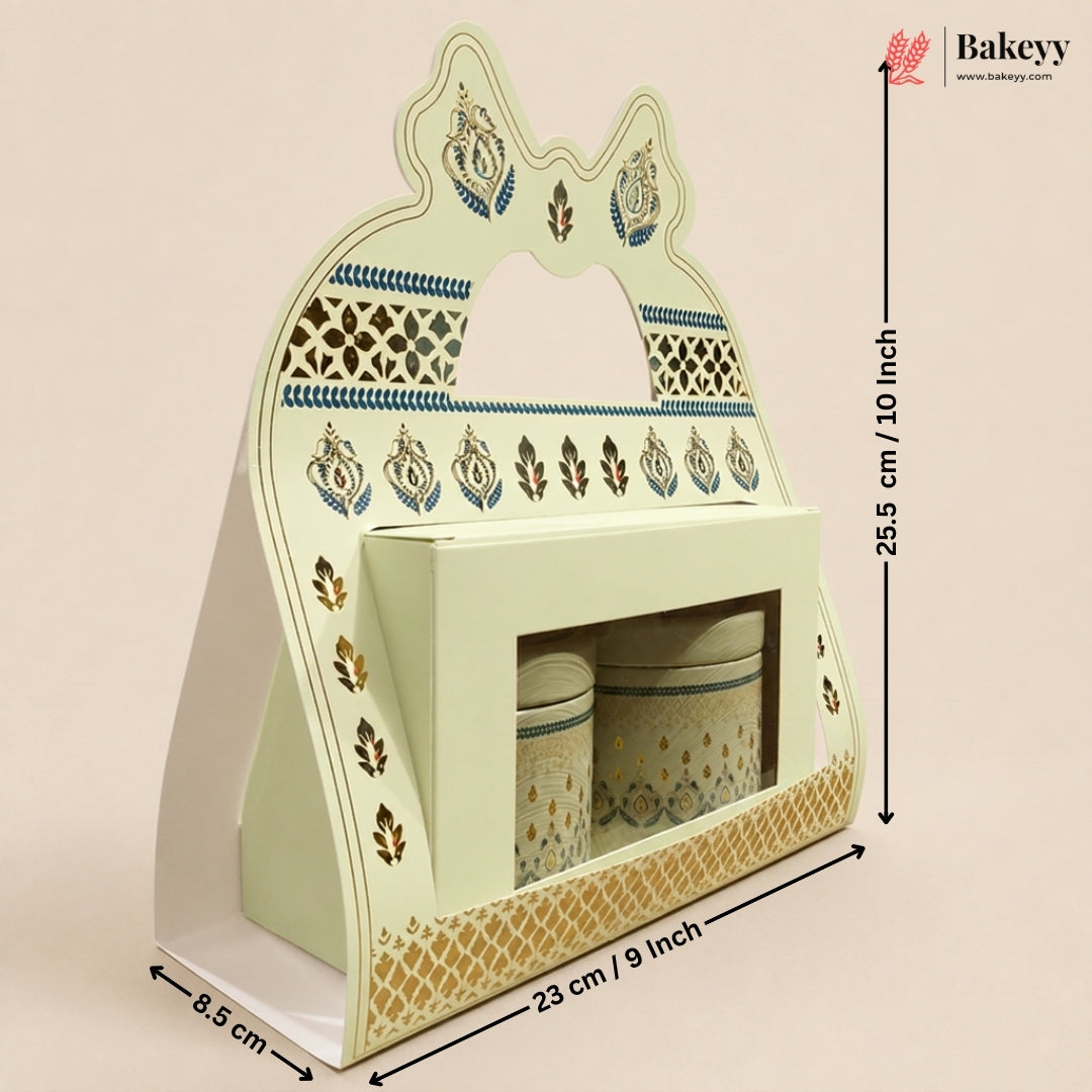 A decorative pastel green and gold ceramic tea or coffee cup holder set with two matching canisters, shown with dimension arrows and labels on a plain beige background. The Bakeyy logo appears in the top right.