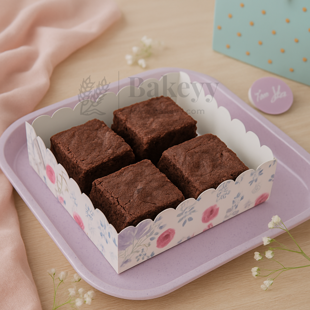Brownies in a decorative box with 'Bakey' branding on a wooden surface.