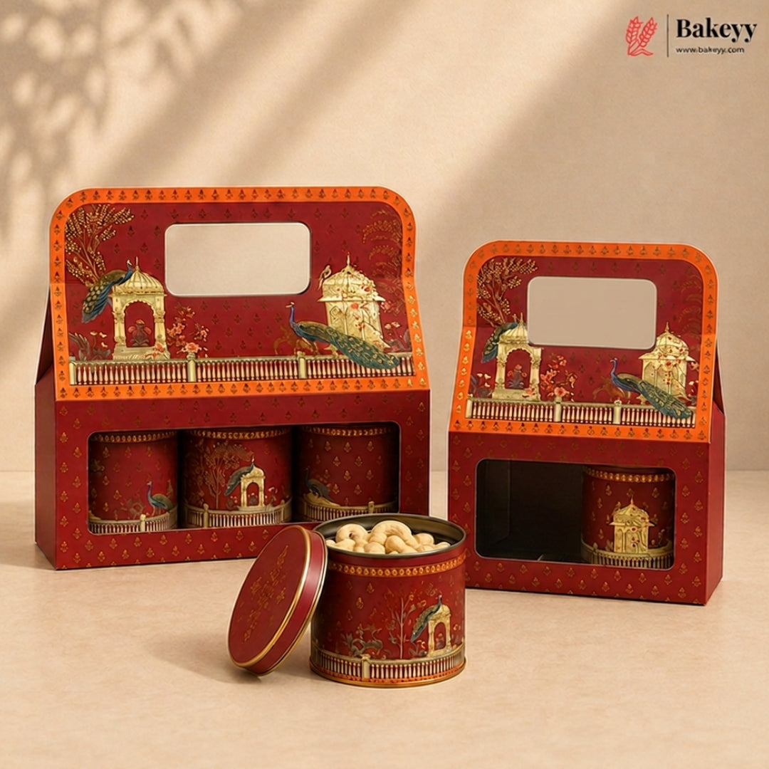 Red decorative gift boxes and matching round tins for sweets or snacks, shown on a warm beige studio background. The packaging features ornate illustrated scenes with peacocks and architectural details, and one tin is open with nuts visible inside.