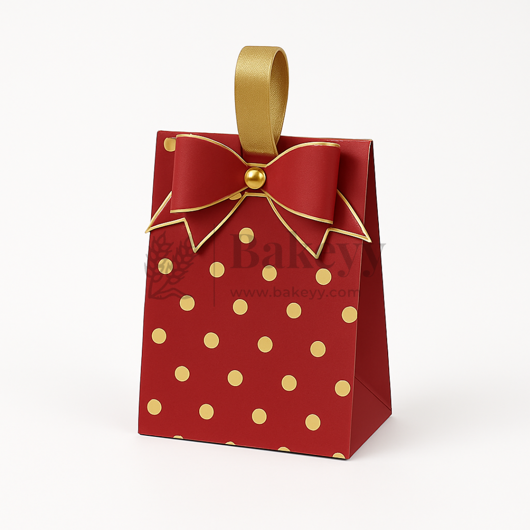 Red gift bag with gold polka dots and a bow on a white background