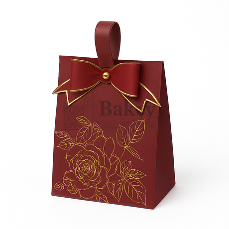 Red bakery bag with gold bow and floral design on a white background