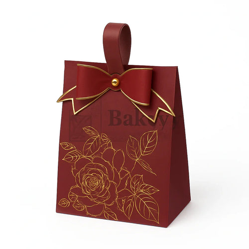 Red bakery bag with gold bow and floral design on a white background