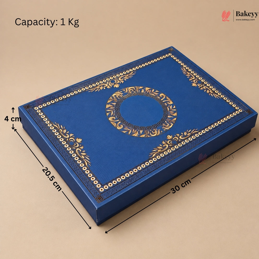 A royal blue rectangular bakery gift box with ornate gold foil detailing, shown with dimension lines indicating measurements of 30 cm, 20.5 cm, and 4 cm, and a text overlay stating 'Capacity: 1 Kg'.