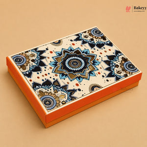 A rectangular gift box with a vibrant orange base and lid decorated with an intricate blue, beige, and brown mandala pattern, set against a solid beige background.