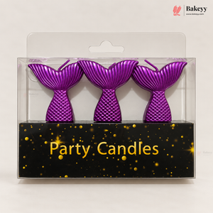 Three purple mermaid tail party candles in a clear plastic blister pack with a black base printed with the words 'Party Candles' and gold speckles. A Bakeyy logo is visible in the top right corner.