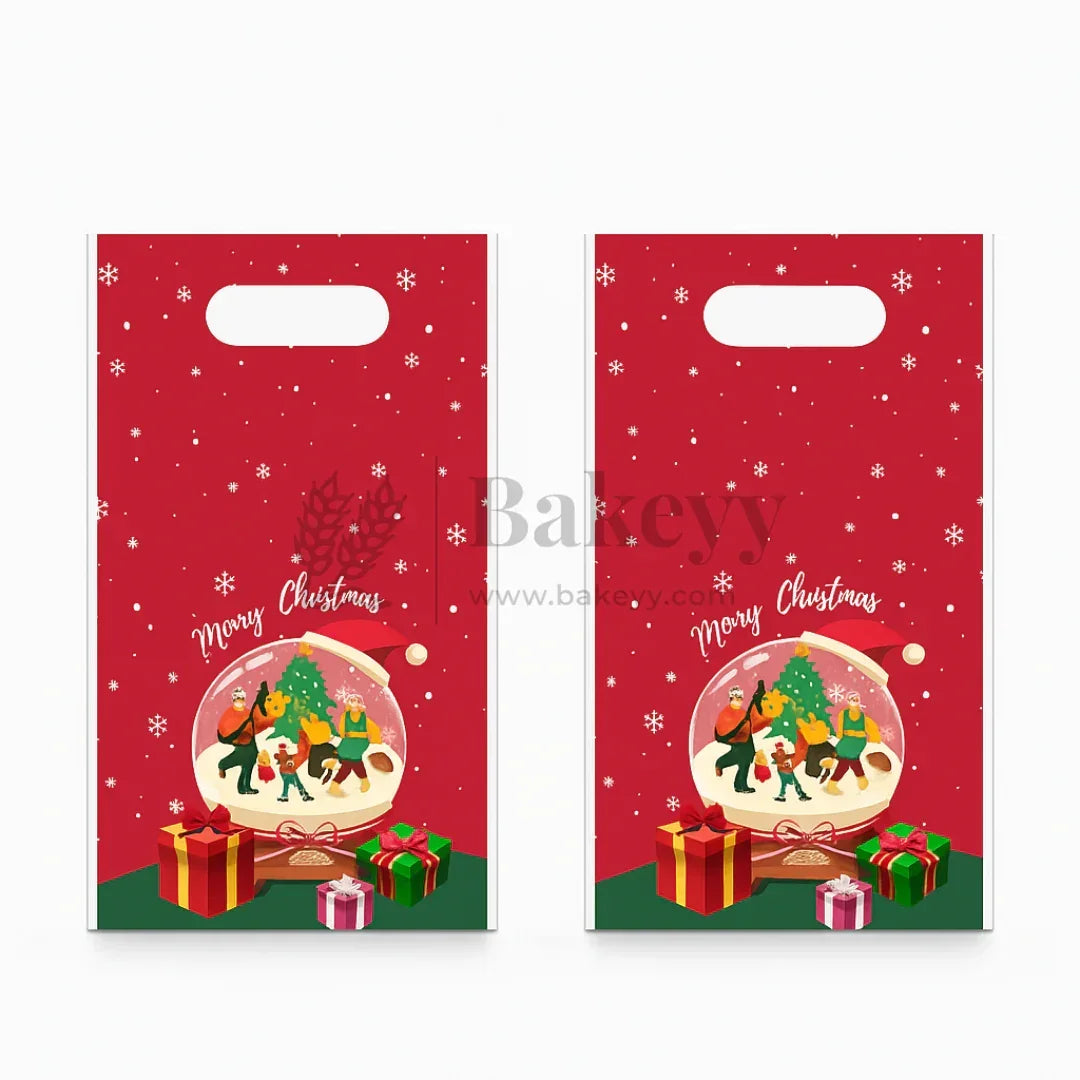 Two red Christmas gift bags with a snow globe design featuring Santa Claus, reindeer, and gifts.