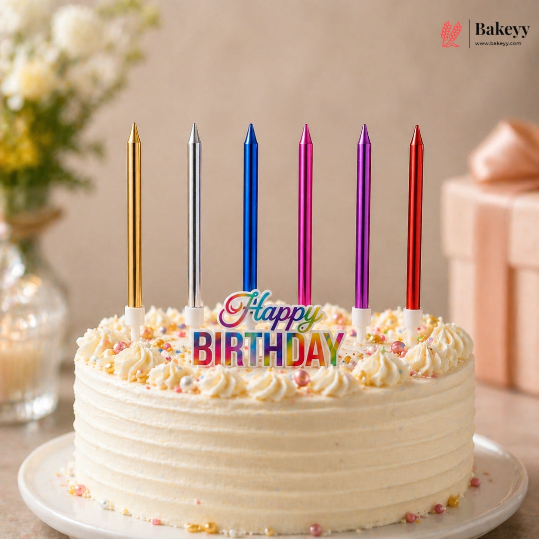 Birthday cake with colorful candles spelling 'Happy Birthday' on a table with a decorative background.