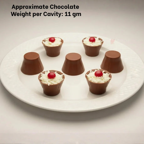 Dome cylinder chocolate mould candies on a white plate, topped with cream and red cherry, Bakeyy baking supplies.
