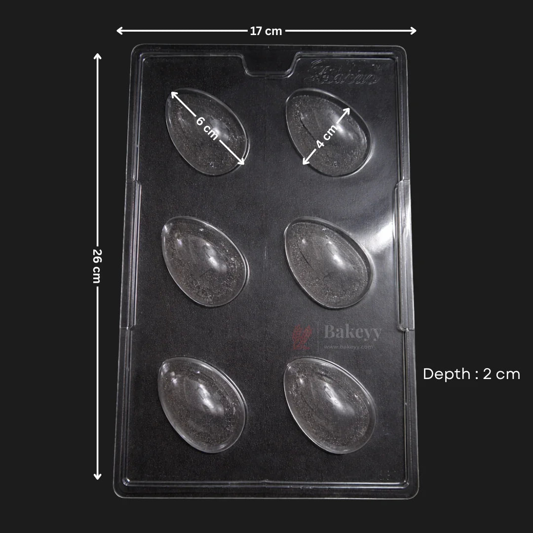 Clear plastic Easter egg chocolate mould tray with six cavities, labeled dimensions 26x17x2 cm, Bakeyy baking accessory.