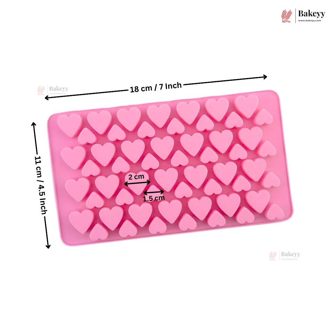 Pink rectangular silicone mold with heart-shaped cavities, shown with black dimension arrows and text indicating 18 cm by 11 cm (7 x 4.3 inches), on a white background with Bakeyy branding.