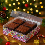 Box of brownies with a decorative box on a festive background with lights and Christmas decorations.