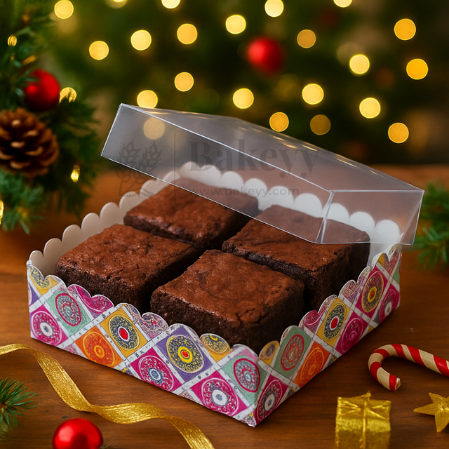 Box of brownies with a decorative box on a festive background with lights and Christmas decorations.