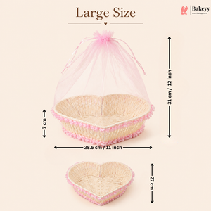 Heart-shaped wicker basket with pink mesh cover and measurements on a beige background