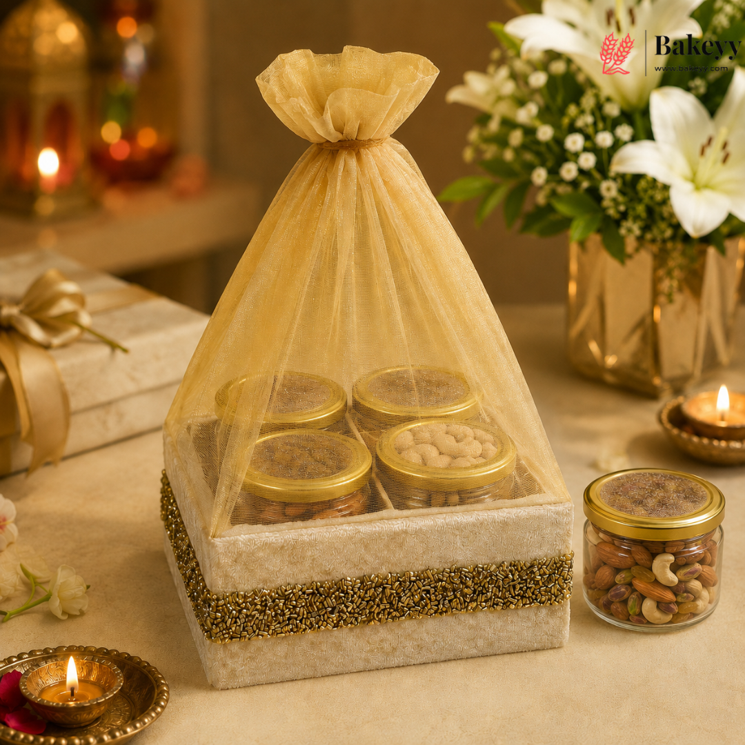 Gift set with jars of dry fruits in a decorative box on a table with candles and flowers.