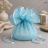 Light blue lace drawstring bag with decorative ribbon on a neutral background