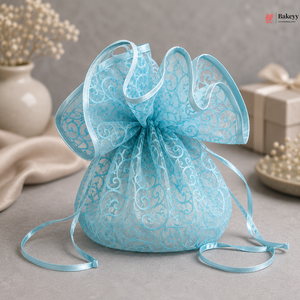 Light blue lace drawstring bag with decorative ribbon on a neutral background