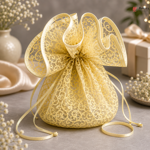 Decorative gold lace bag with a bow on a neutral background