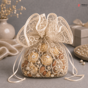 Decorative bag with gold and bronze ornaments and pearls on a gray surface.