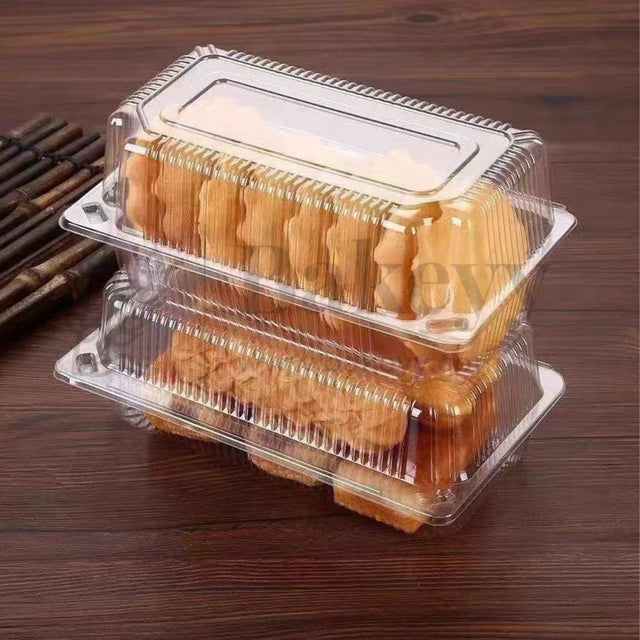 Two clear plastic containers with cookies on a wooden surface