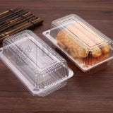 Clear plastic food containers with baked goods on a wooden surface