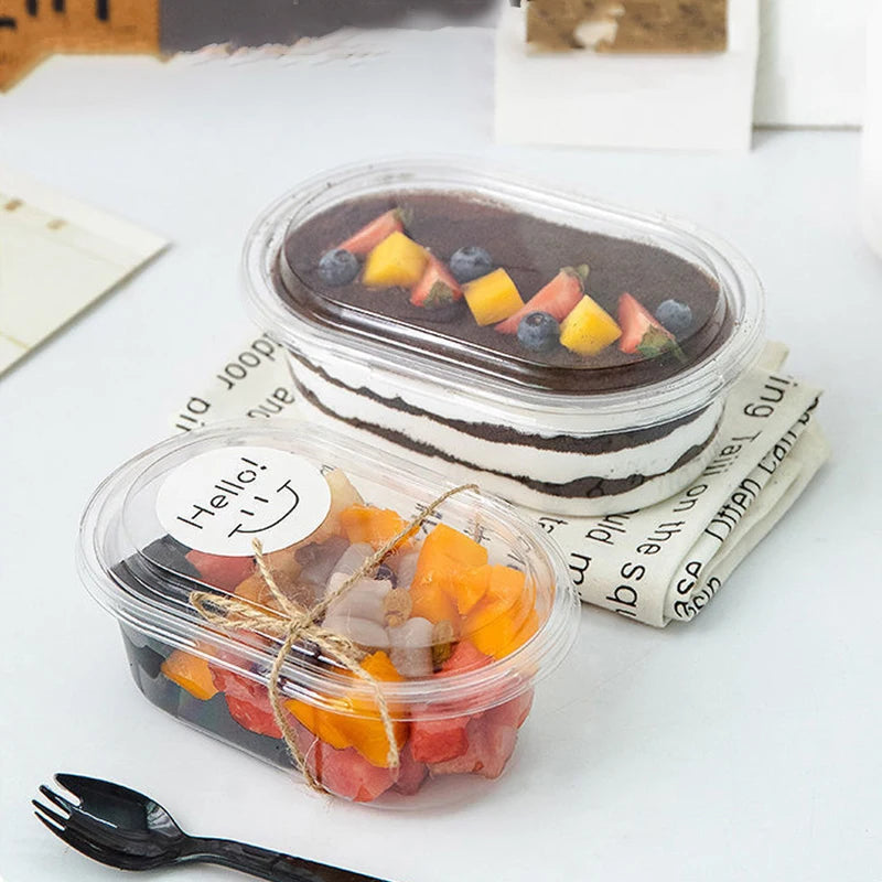 Two dessert containers with fruit on a white surface