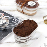 Two dessert containers with layered fillings on a marble surface