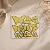 Pack of butterfly-shaped stickers on a beige surface with a natural background