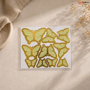 Pack of butterfly-shaped stickers on a beige surface with a natural background