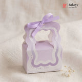 Lavender gift box with ribbon on a beige background, featuring the Bakeyy brand.