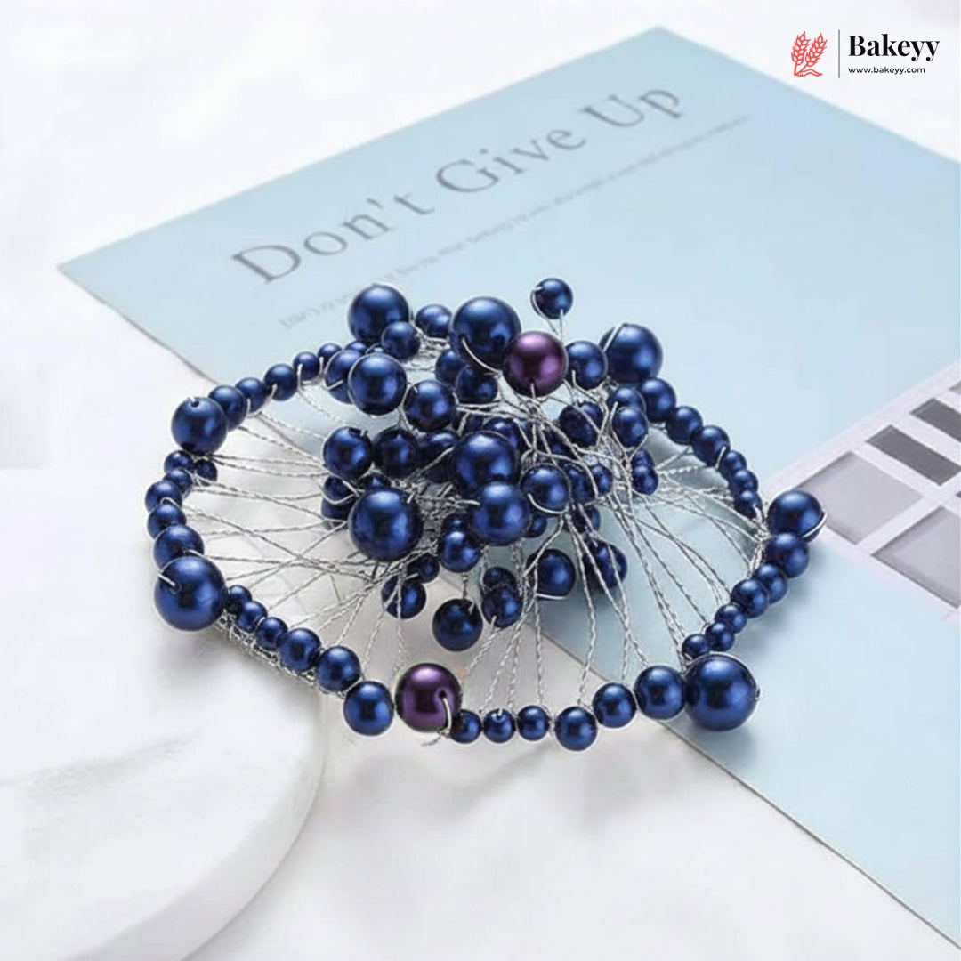 Blue beaded hair accessory on a light blue background with 'Bakeyy' branding.