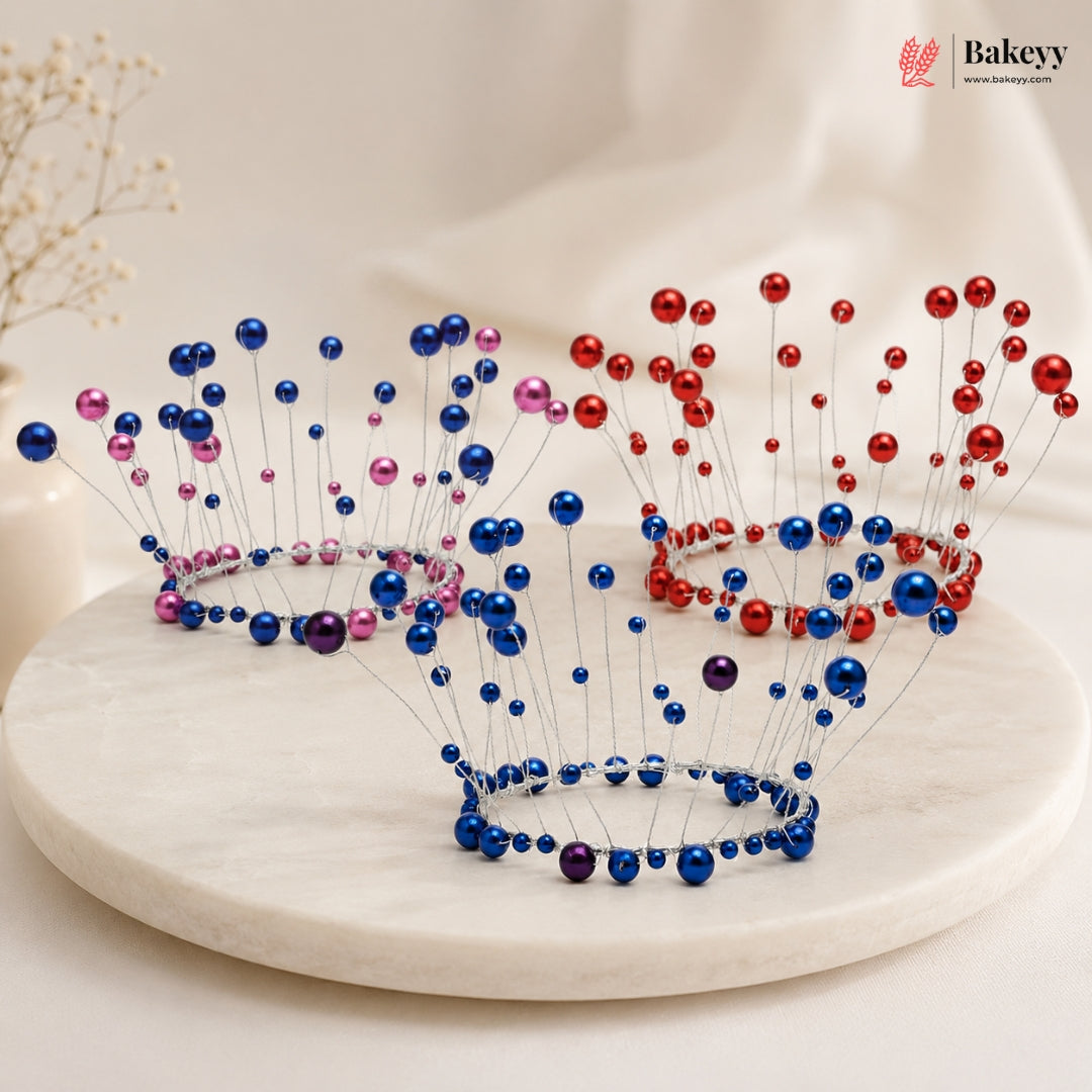 Two decorative tiaras with blue, red, and pink beads on a white surface.