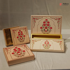 Three decorative rectangular gift boxes with floral arch illustrations in red, green, and gold on a cream background, arranged on a light fabric backdrop. One box is open to show a gold interior, and a small Bakeey watermark appears in the top right.