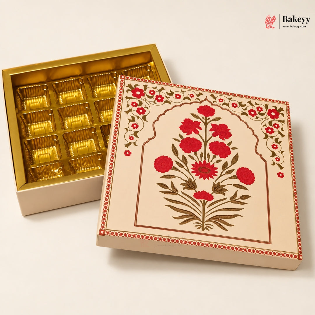 An open gold-plated chocolate box with multiple foil-wrapped chocolates inside, shown next to its decorated cream-colored lid featuring a red and green floral design. The Bakeey brand logo is visible in the top right corner.