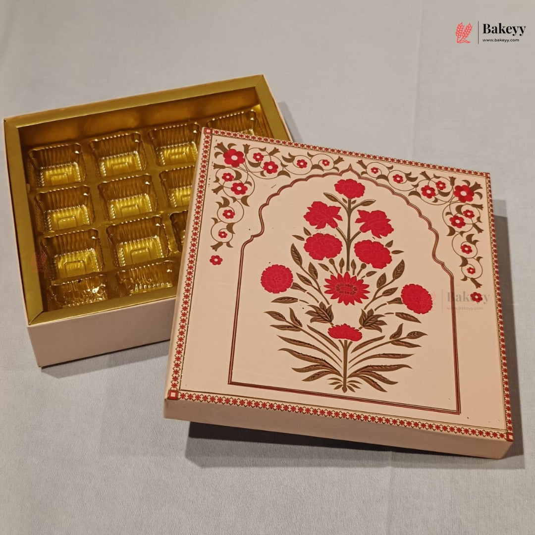 An open gold-lidded gift box showing individual wrapped chocolates inside, next to a closed decorative box with a beige floral design in red and brown on a light gray background.