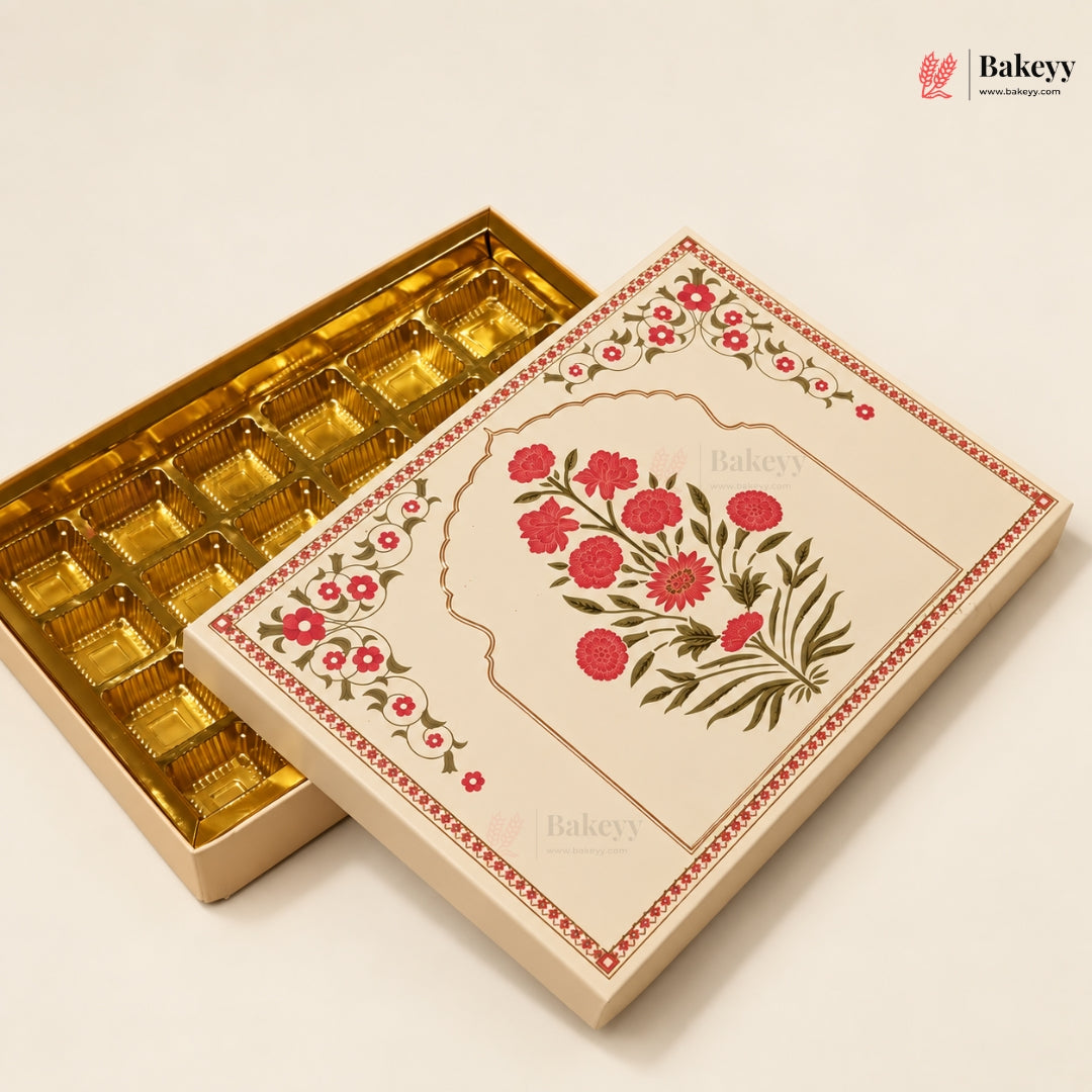 An elegant rectangular gift box for chocolates, shown open with a gold foil-lined tray visible inside. The lid features a cream-colored background with a central arch illustration decorated with red flowers and green leaves, bordered by a red patterned frame.