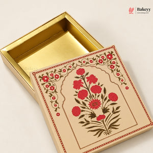 A square decorative gift box with a gold interior and a cream-colored exterior lid featuring a red floral illustration and ornate border, shown open on a light beige background.