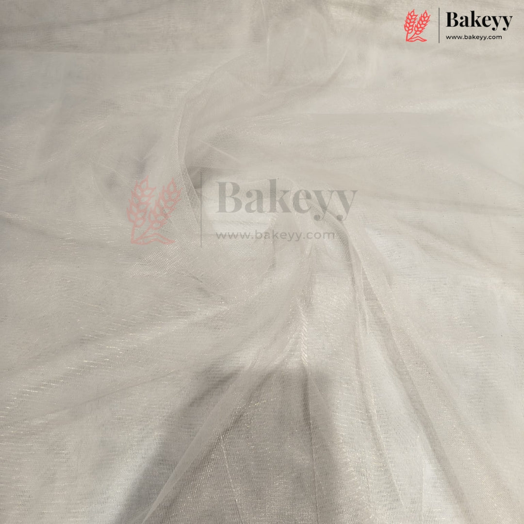 White tulle fabric draped to show its sheer, semi-transparent texture and fine mesh structure. The Bakeyy brand logo is visible in the top right corner.